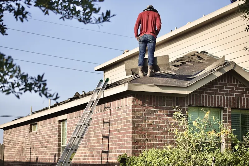 Professional roofer working on a residential roof in North Hill